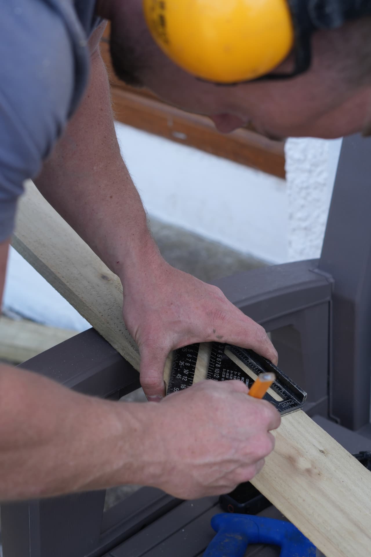 A Frontier Fencing installer measuring timber for a gate